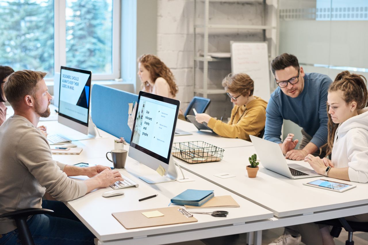 A working group coordinating tasks around an office table