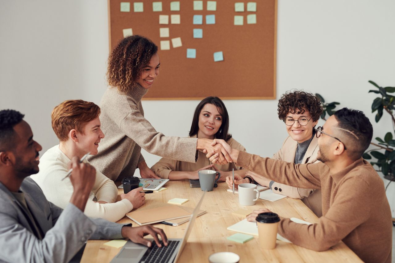 Professionals sharing ideas around a workshop table